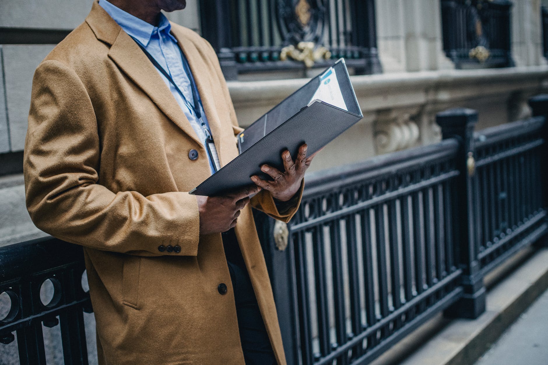 black entrepreneur reading documents on street